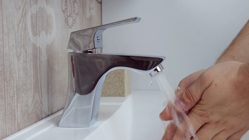 a man taking a bath in a bathroom sink