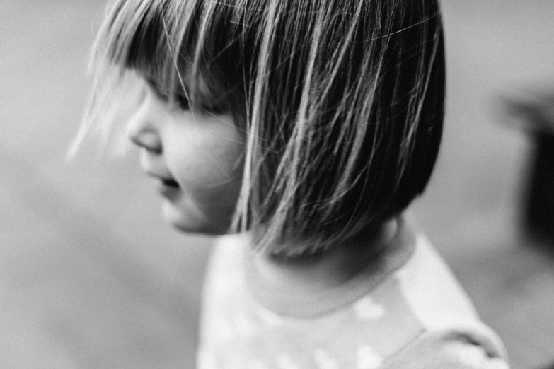 young child with medium bangs looking at soing