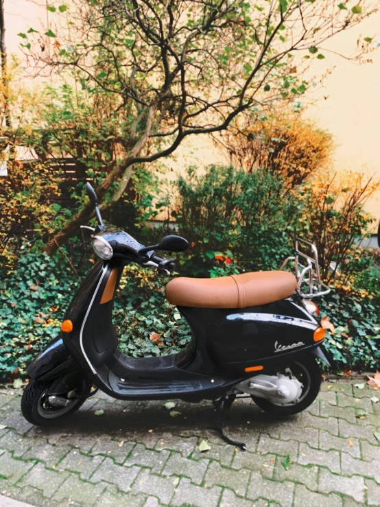 a scooter is parked outside on the sidewalk