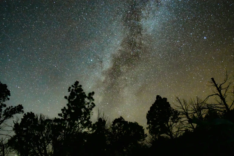 a view of the night sky with stars above it