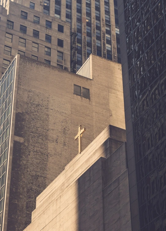 the image of a church with a cross above it and two other buildings