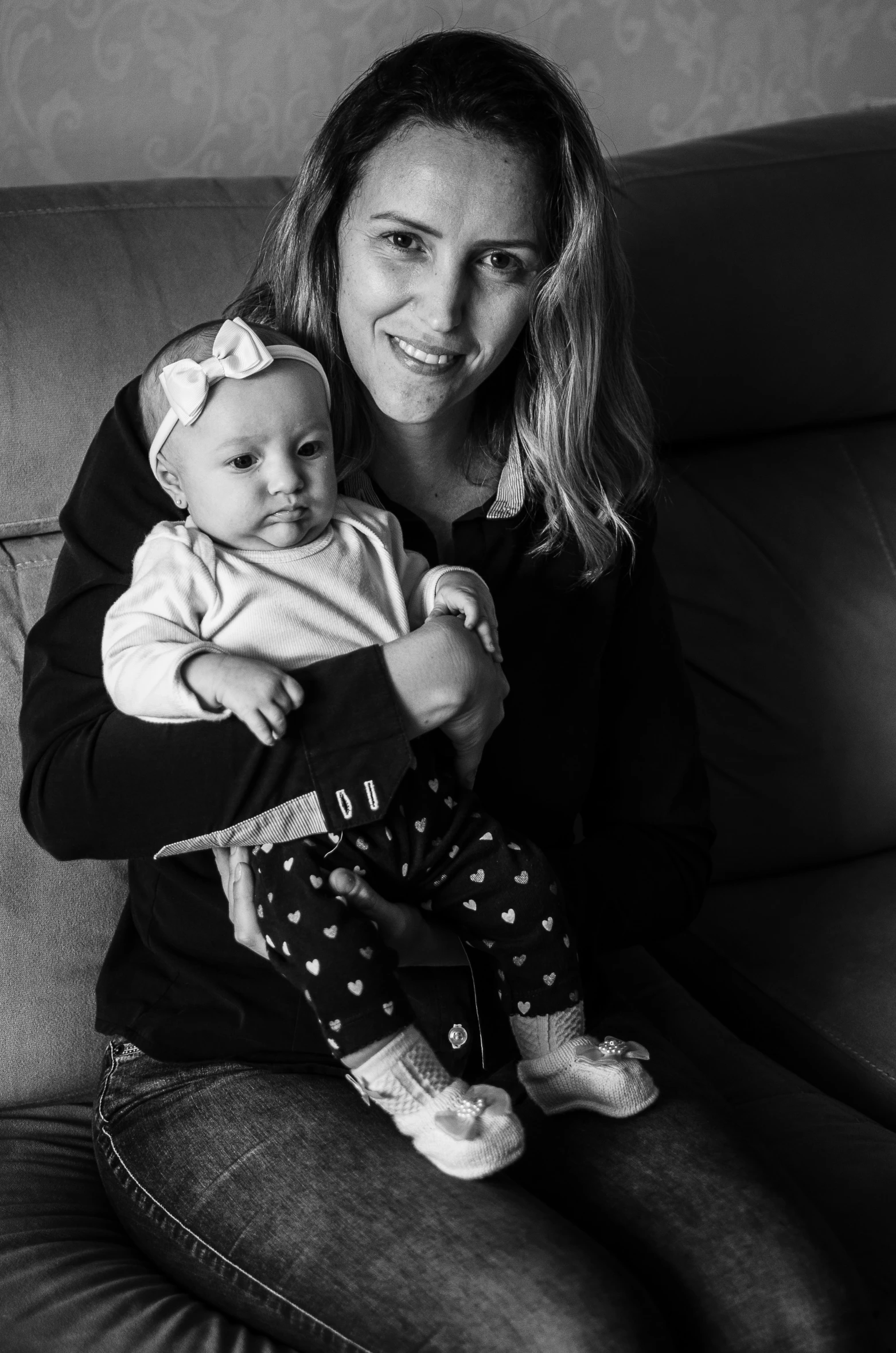 a black and white image of a woman holding a baby