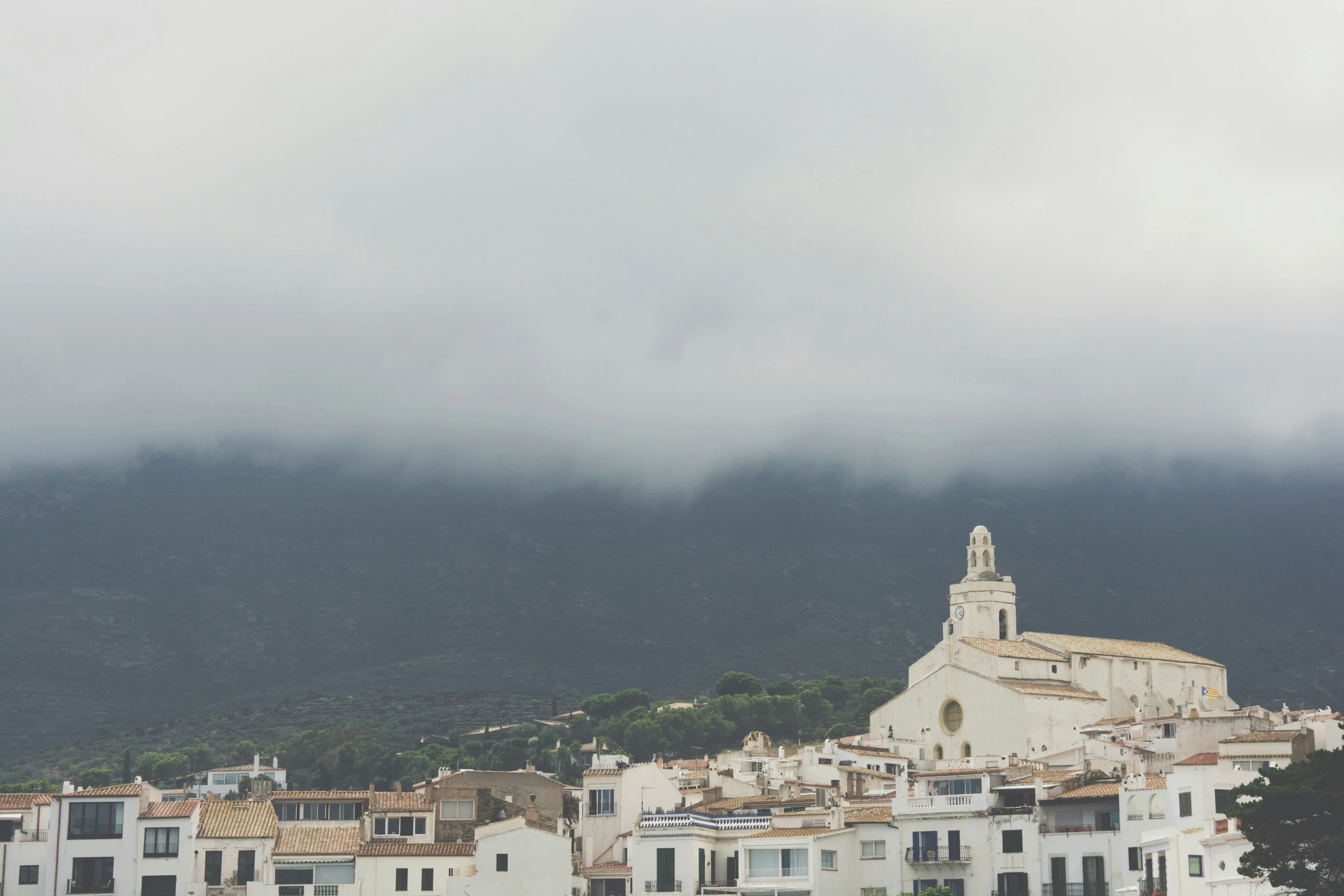 the city is surrounded by white buildings and mountains