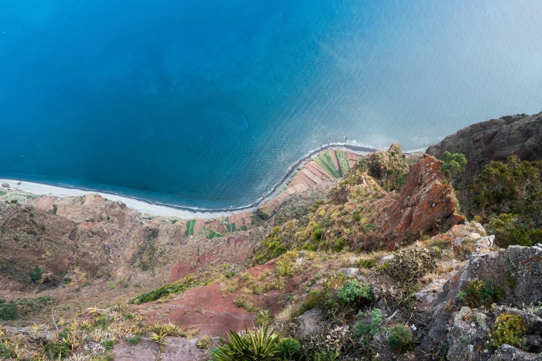 a mountain view of a lake surrounded by mountains and plants