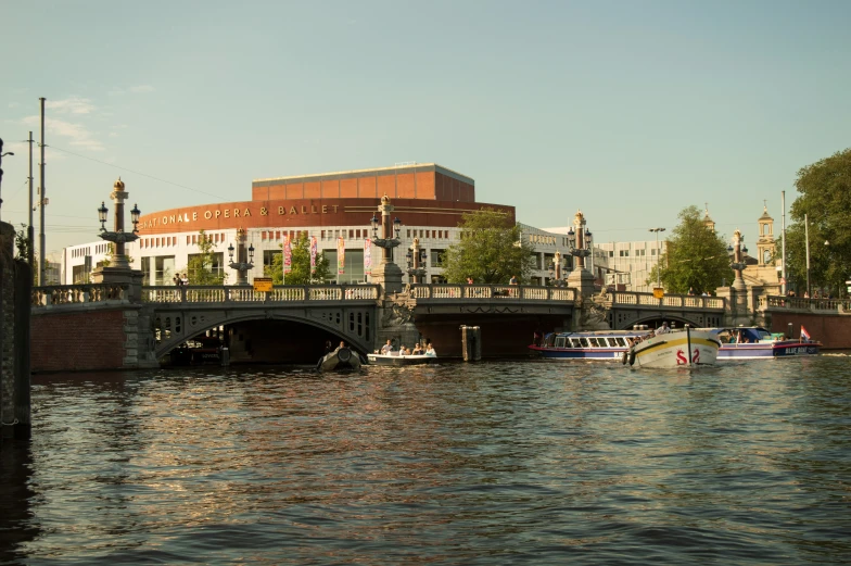 a river with a bridge and buildings on it