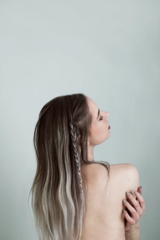 an image of a woman that is holding her hair in front of her head