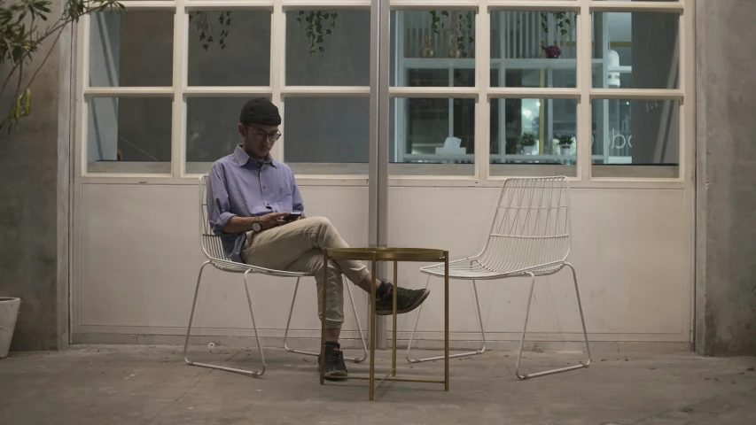 a man sitting in an office with his feet up on a chair