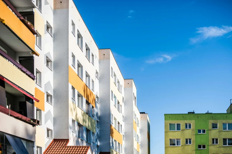 a view of an orange and white building in a residential area