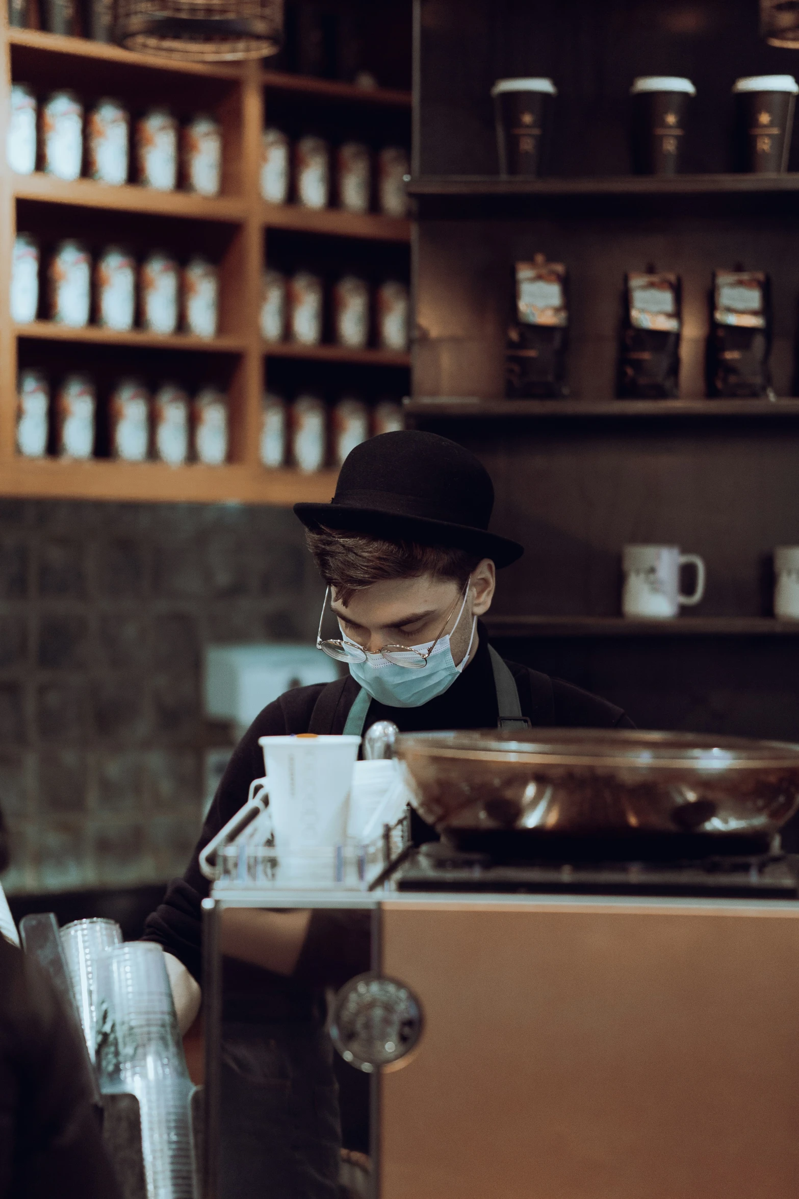 a restaurant worker preparing food behind an oven