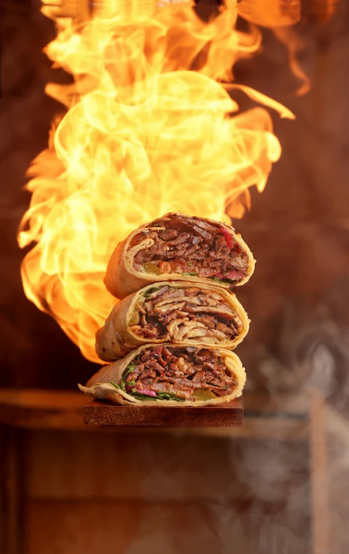 there are three wraps stacked up over the fire