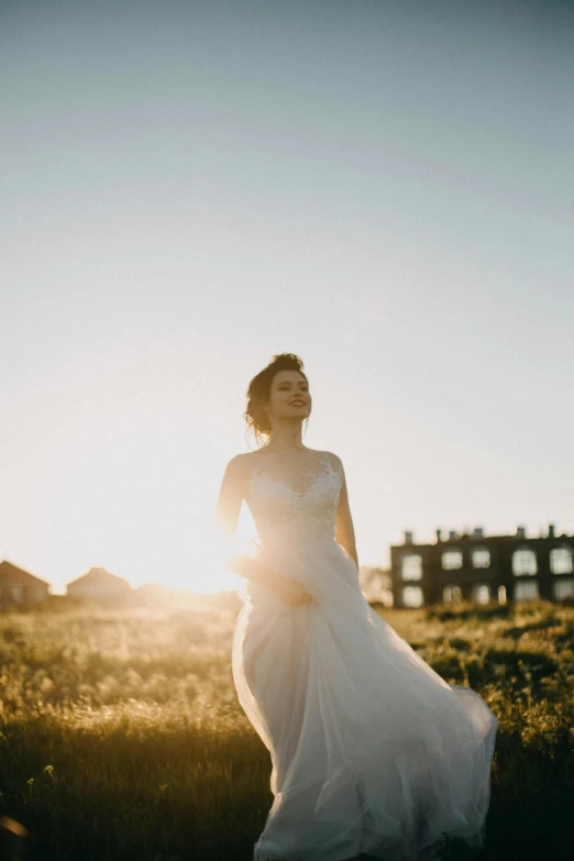 a woman in a wedding dress walking away from the camera