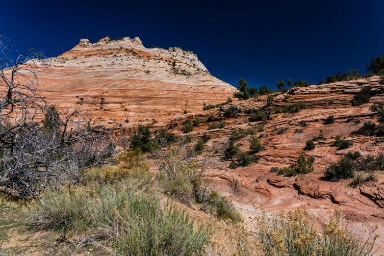 a hill side with dirt and grass on the sides