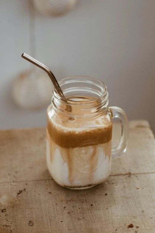 a jar of iced coffee sits on a  board