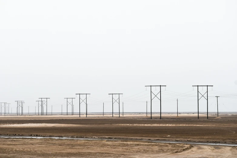 a group of lines on a desert field with an airplane