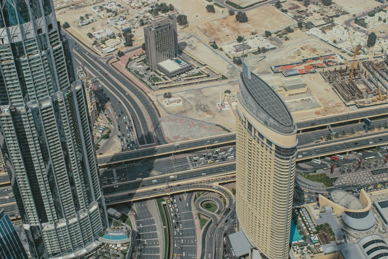 aerial view of two buildings and a highway in the middle of a city