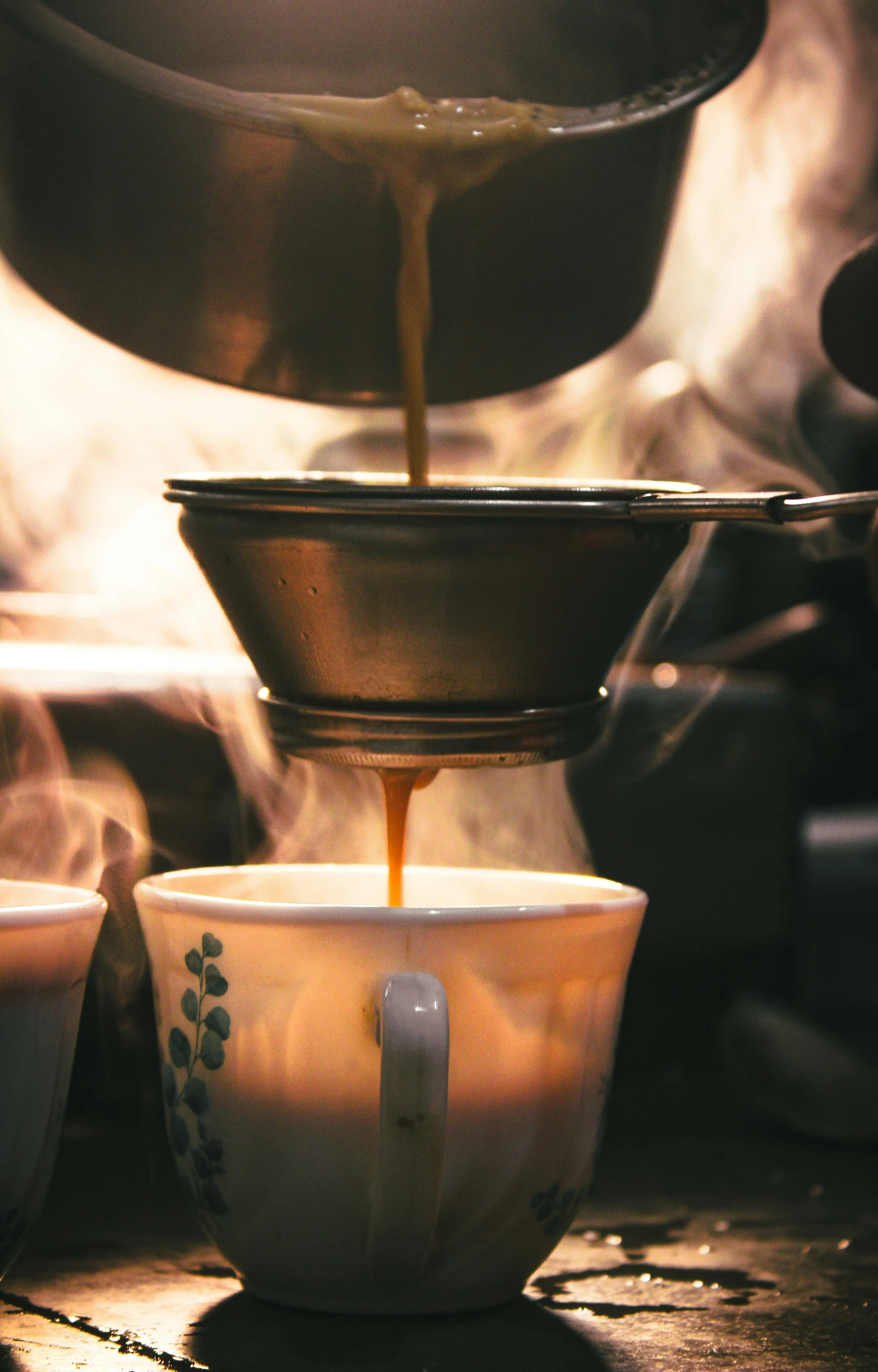 a cup of tea being filled with  coffee