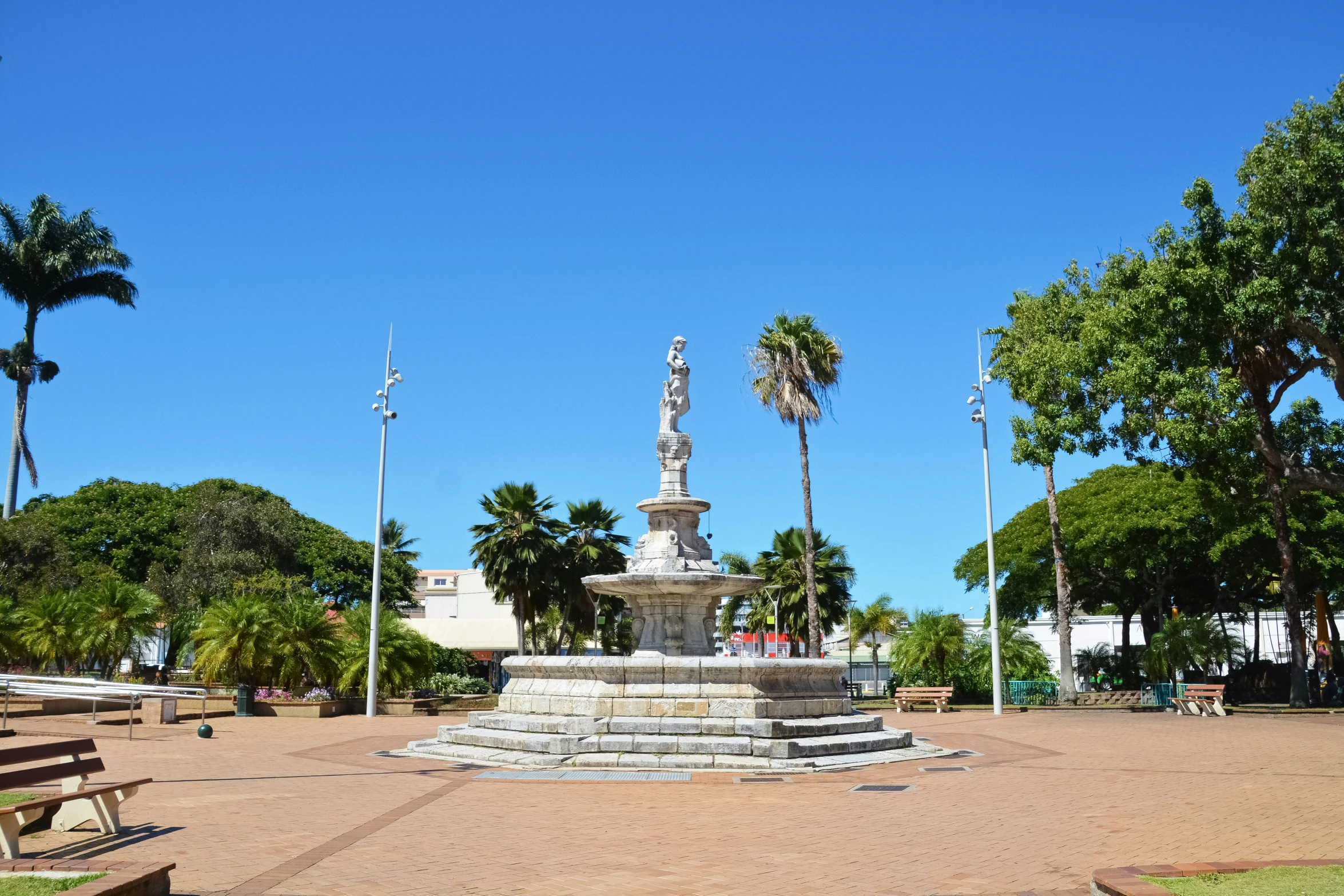 a park area with benches, and fountain in center