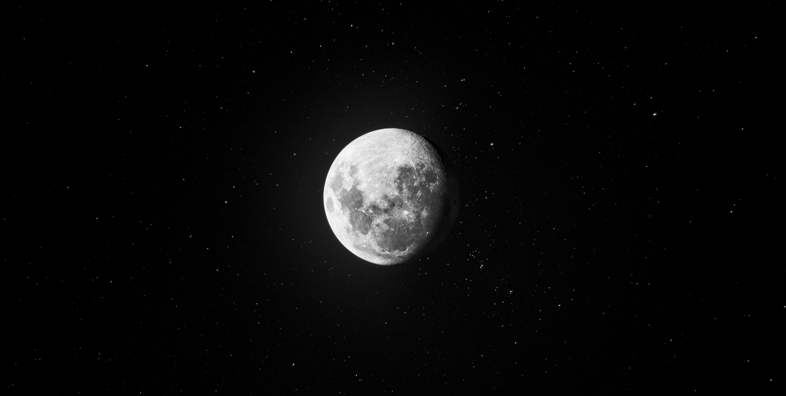 a moon seen through a black sky at night