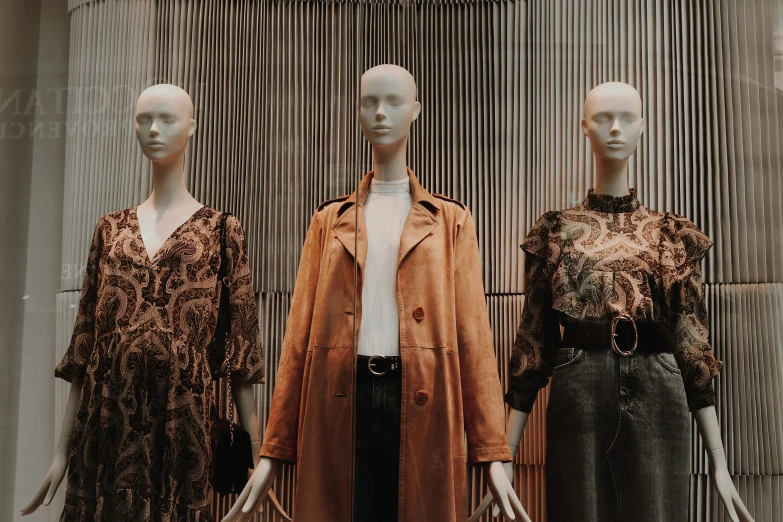 three mannequins are dressed in different styles of clothing