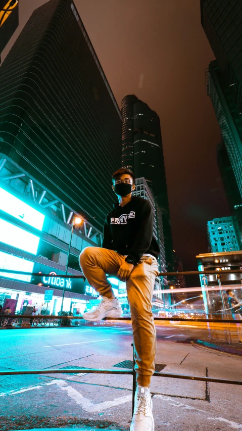 a man sitting on top of a pole in the middle of an empty street