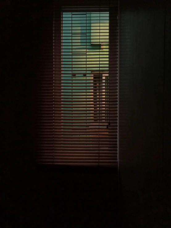 a person sitting at a desk in a darkened room