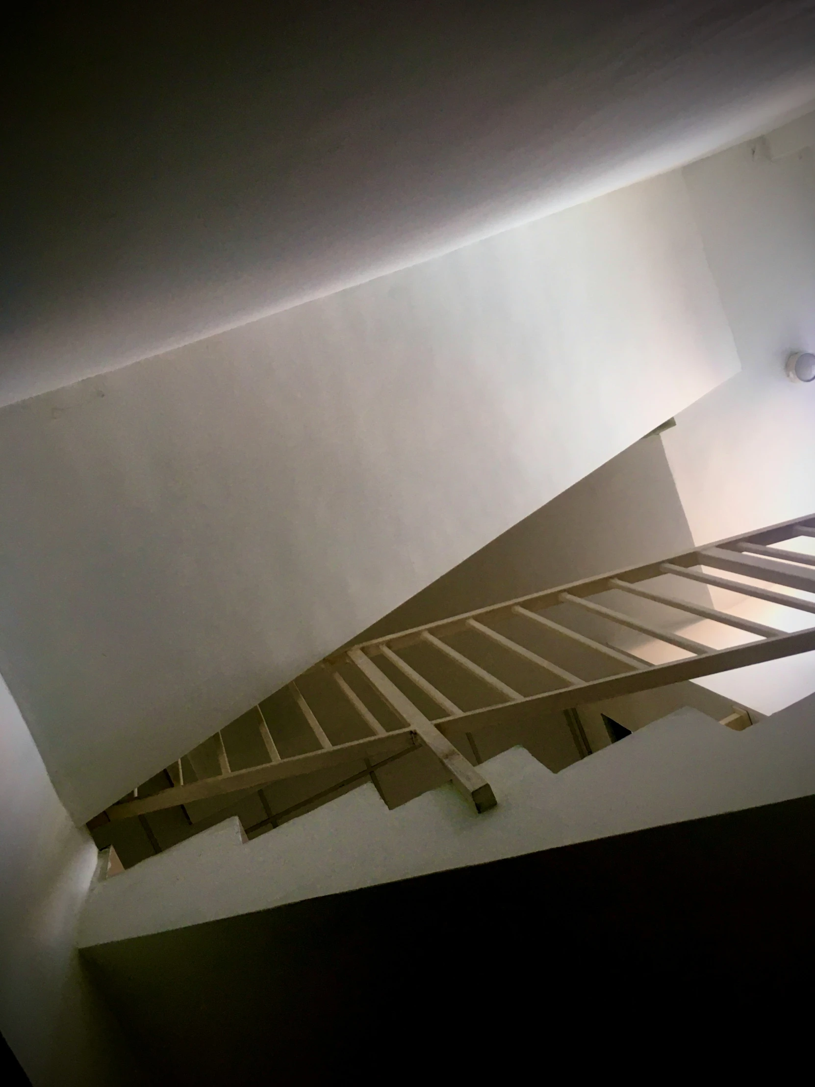 there is a large metal stair railing above a bed