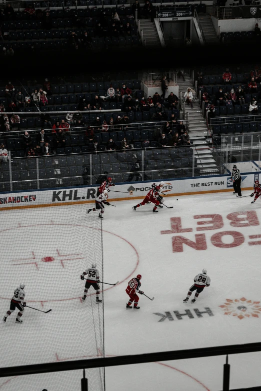 an outdoor hockey rink with many people watching