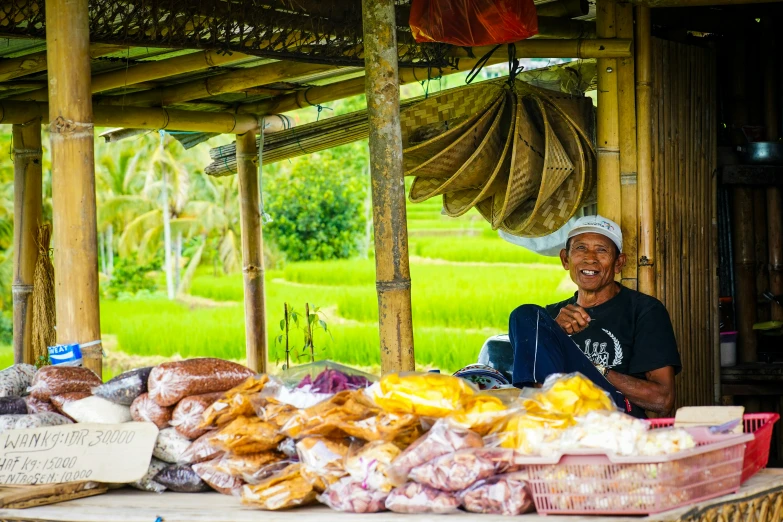 a man is selling bread, potatoes, and other foods