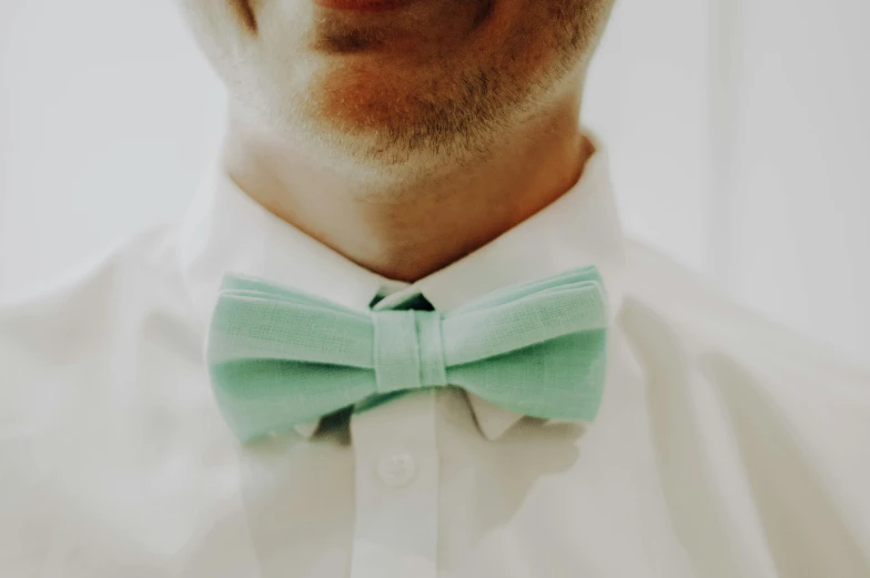 a man wearing a mint green bow tie