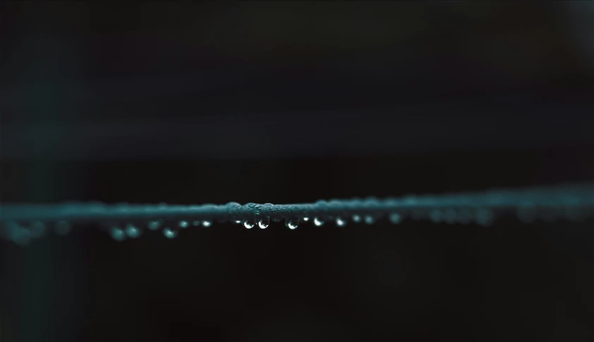 water droplets on a string with black background
