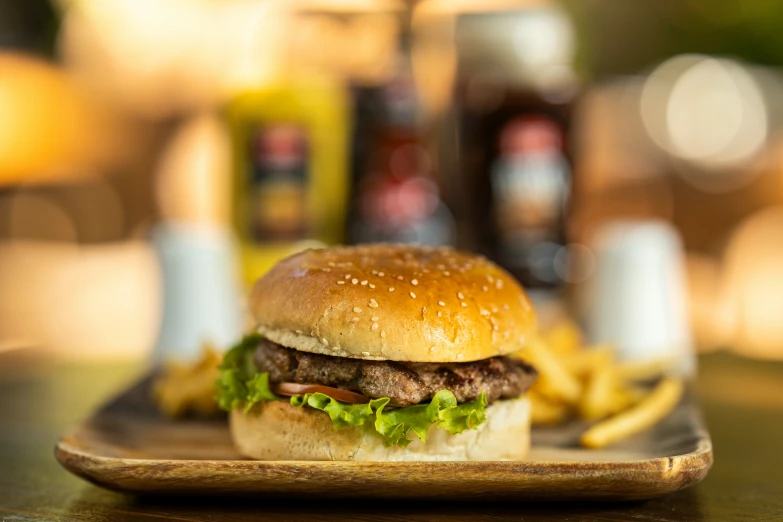 a burger is served with french fries on the side