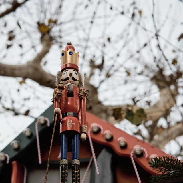 a wooden nuter sculpture in front of a tree