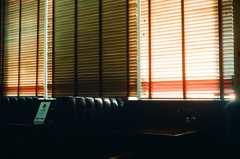 an open window that has wooden blinds covering it