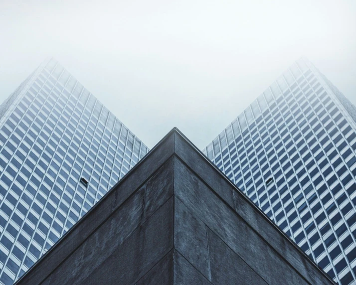 a very tall black building with some very tall buildings in it