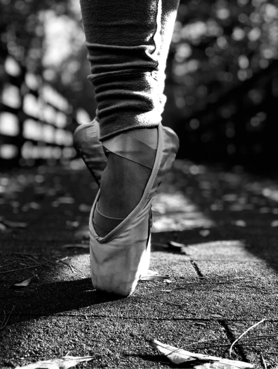 black and white pograph of a person's shoes