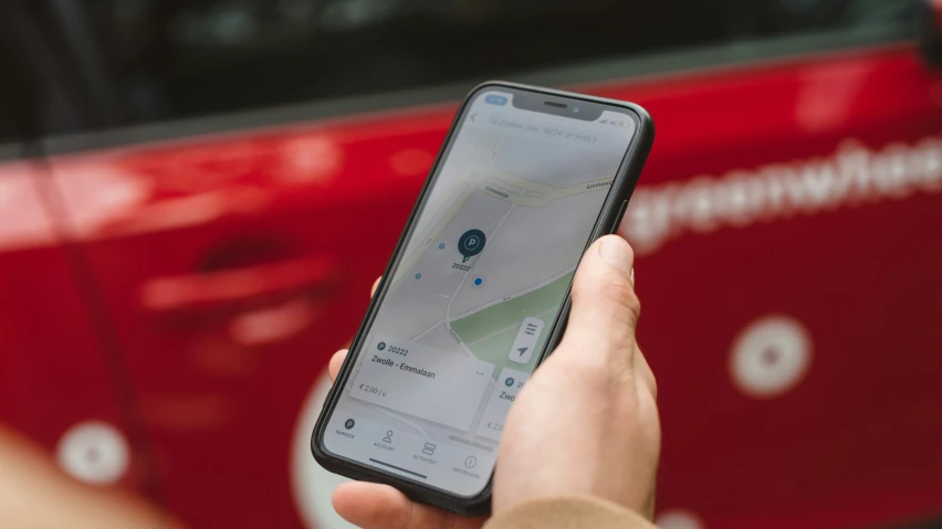 a woman is holding her phone with a road map on it