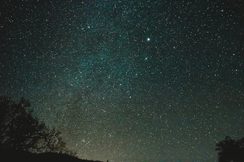 a man looking up at the sky full of stars