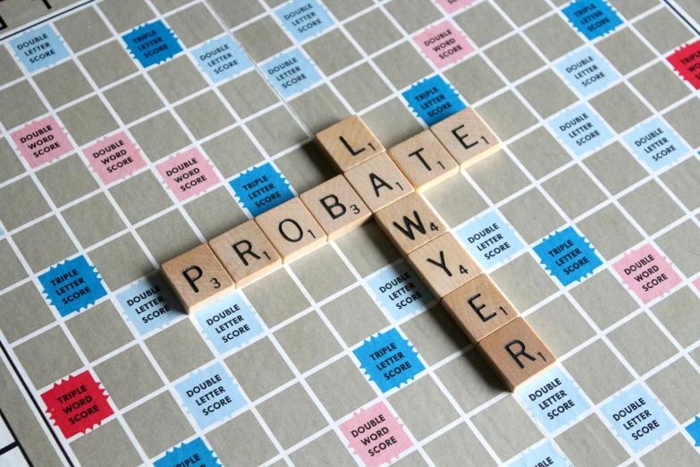 scrabble board with words saying'probatie news'and several dices