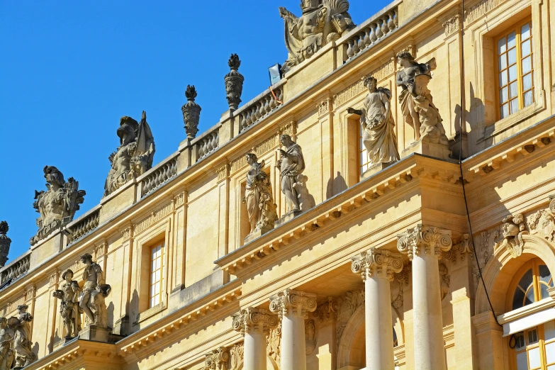 some statue's on the facade of a building