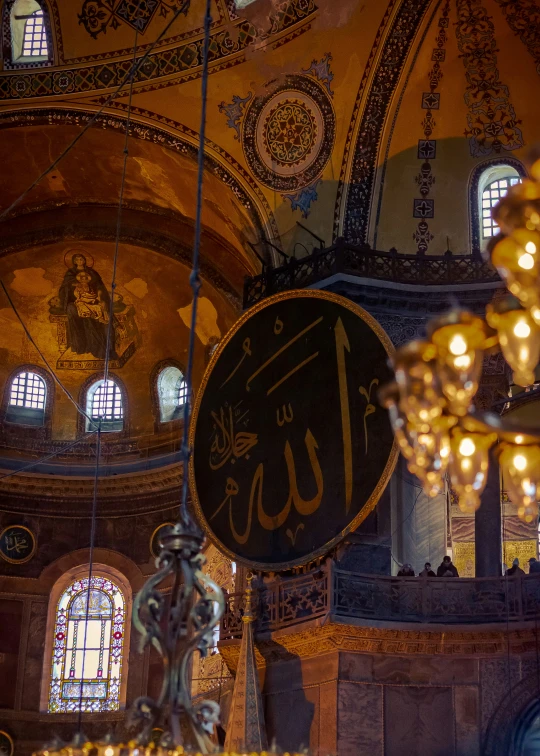 a hanging sign in the middle of an ornate building