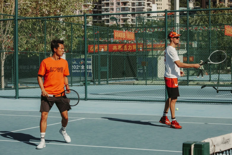 two men on a tennis court playing a game