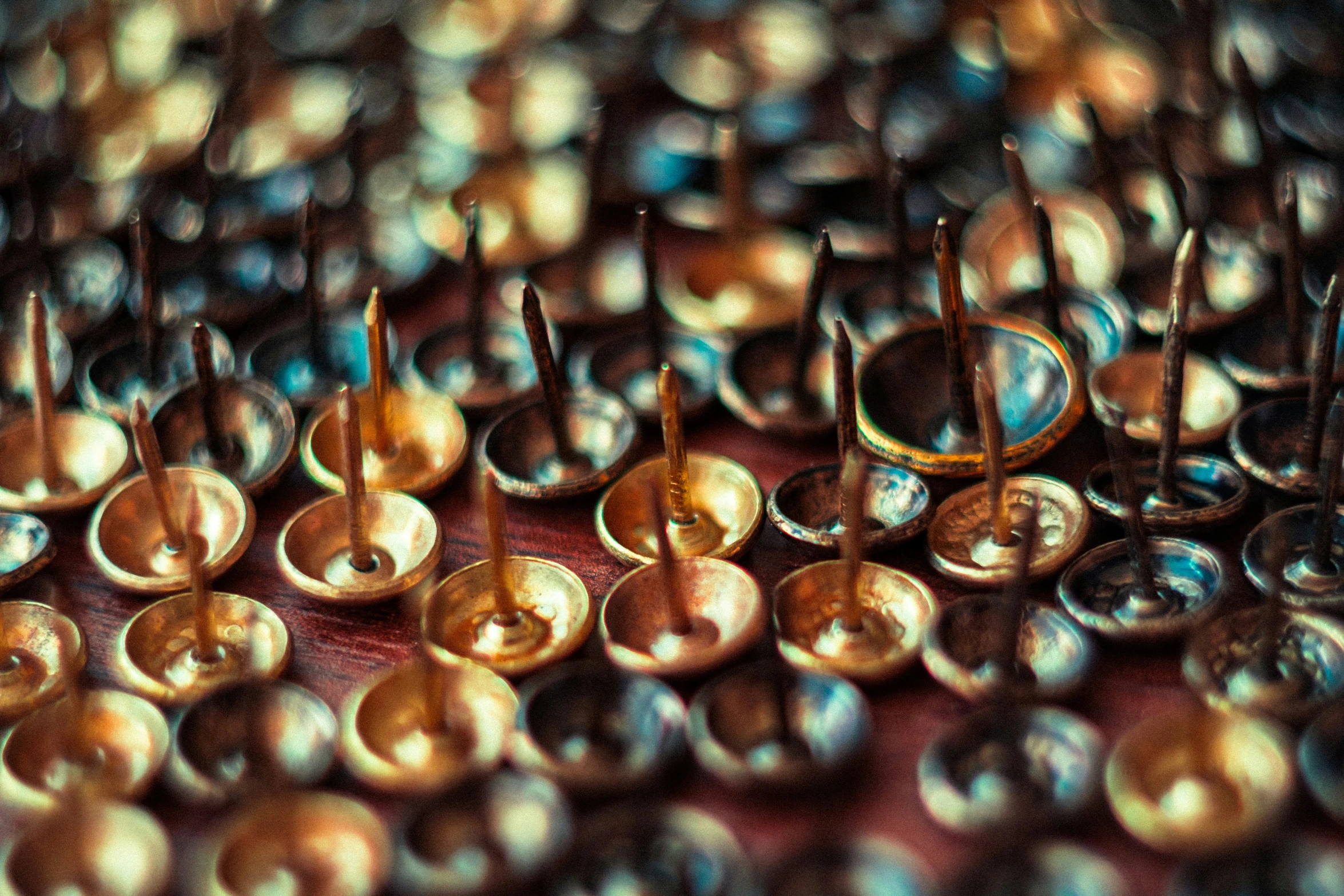 several pairs of gold earrings are displayed in different directions