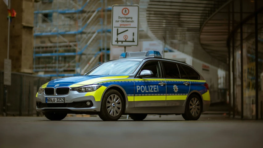 a police car is parked on the street in front of a building