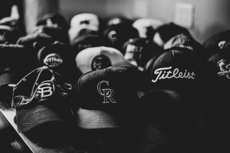 a crowd of baseball caps are lined up