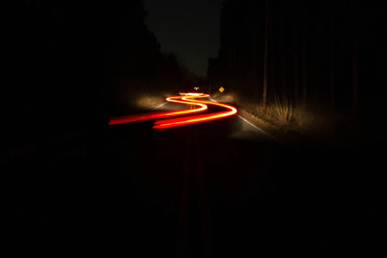 the image of a highway in motion in the dark