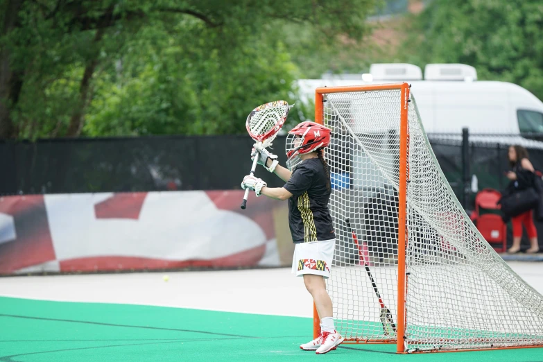 the player is practicing his goalies at an outdoor ice rink