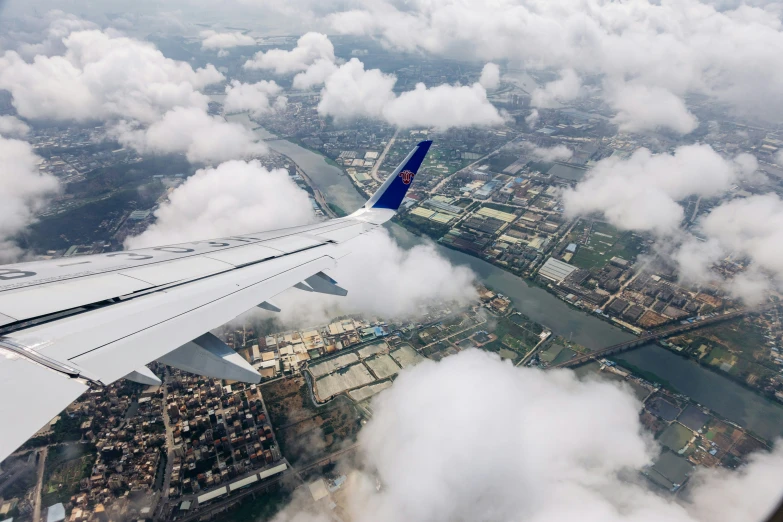 a view of some white clouds and the wing