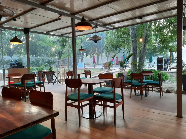 a dining room has wood tables, a metal roof and chairs