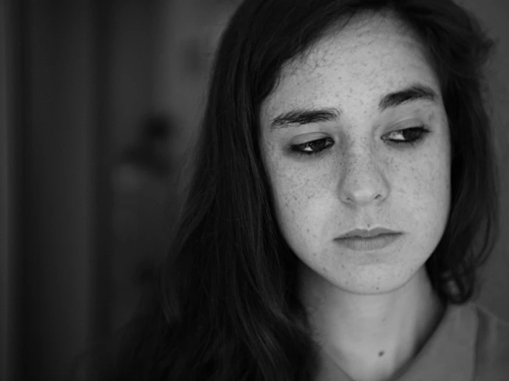 the black and white image shows an unhappy girl