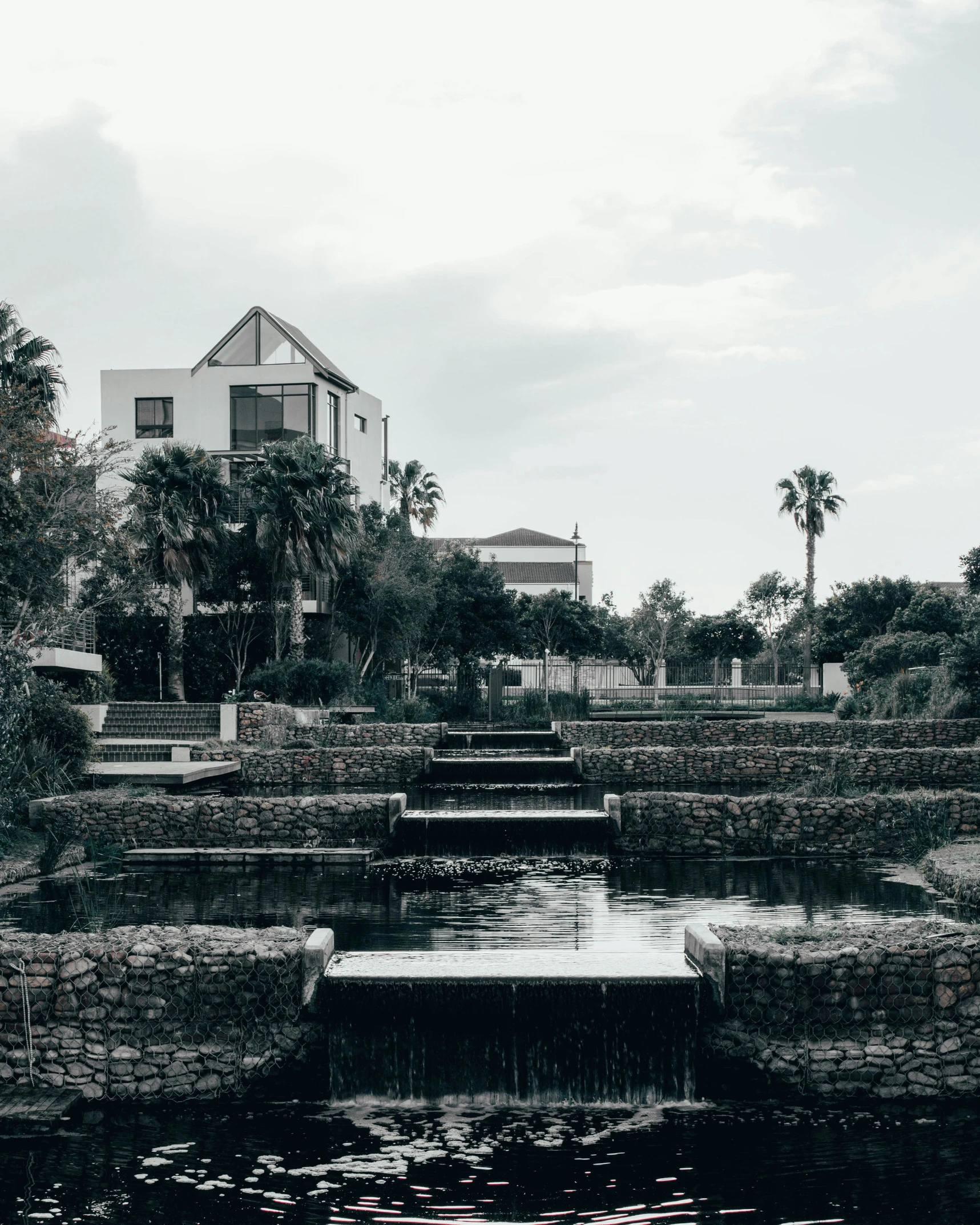 a building next to some water and trees